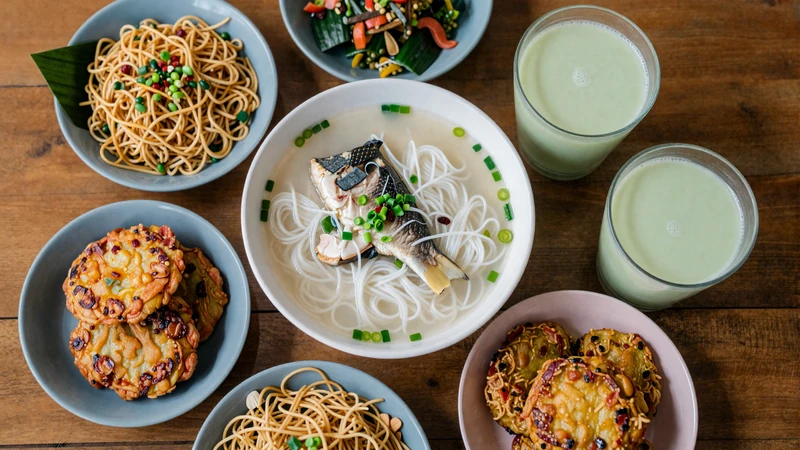 Traditional Burmese meal spread with mohinga, tea leaf salad, Shan noodles and green tea - Myanmar culinary culture